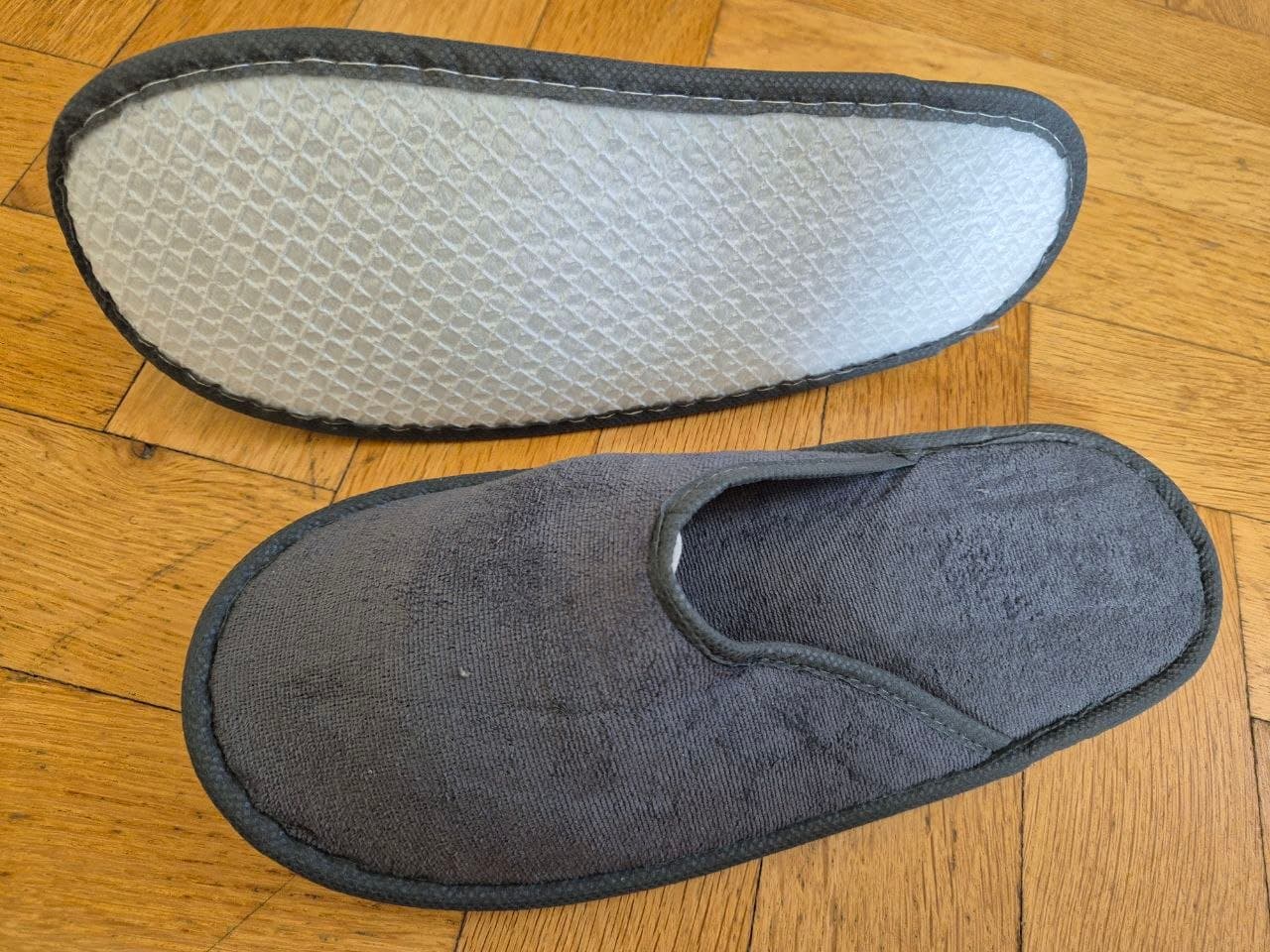 Cotton blended hotel slippers near rattan basket